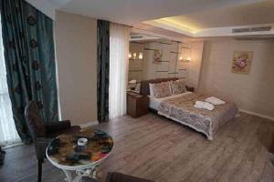 um quarto com uma cama e uma mesa num quarto em ATAKUM PALAS OTEL em Samsun