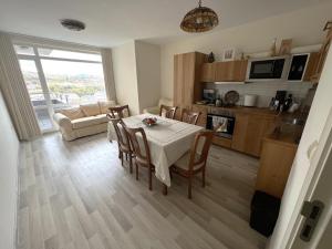 a kitchen and living room with a table and chairs at VANITY Apartments in Sandanski