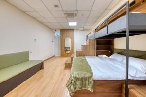 a bedroom with a bunk bed and a staircase at Tropica Inn Hotel in Yerevan