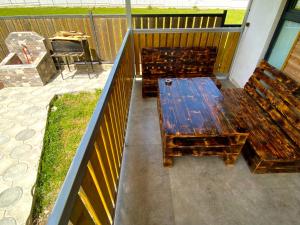 two wooden benches sitting on top of a balcony at Cottage Marta Sadgeri in Borjomi