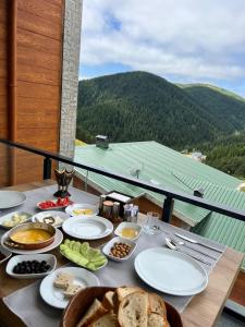 a table with plates of food on top of a balcony at seyir yeri otel cafe&restorant in Trabzon +33 photos
