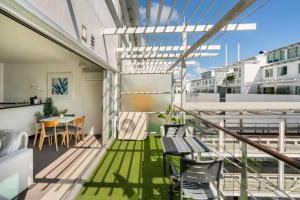 a balcony with a table and chairs on a building at Welcome To Your Secluded Luxury Abode in Auckland