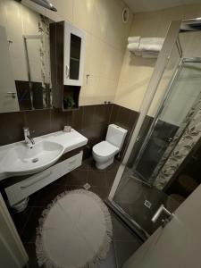 a bathroom with a toilet and a sink and a shower at VANITY Apartments in Sandanski