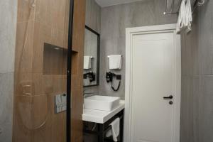 a bathroom with a sink and a mirror at Port Rivoli Baku Luxury Boutique Hotel in Baku