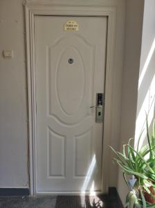 a white door with a sign on it at Tomis 99 Apart in Constanţa