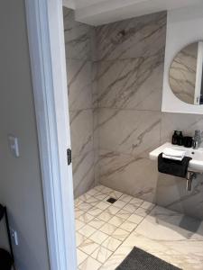 a bathroom with a shower and a sink at Aloe Studio in Cape Town +3 photos