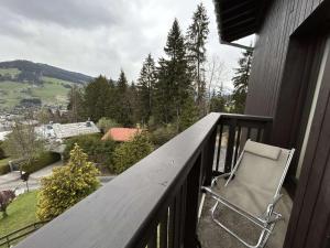 a chair sitting on the balcony of a house at Appartement Megève, 2 pièces, 6 personnes - FR-1-597-7 in Megève