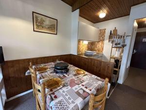 a kitchen with a table with a table cloth on it at Appartement Megève, 2 pièces, 5 personnes - FR-1-597-27 in Megève