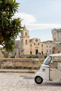 a small car parked in front of a building at Palazzo Del Duca Hotel & Restaurant in Matera