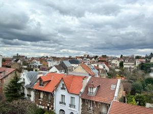 a group of houses with red roofs in a city at 2 pièces lumineux aux portes de Paris in Clamart