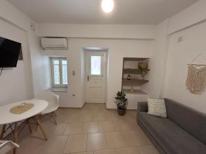 a living room with a couch and a table at Giasemi Syros in Ermoupoli