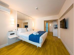 a bedroom with a large bed with a large mirror at Amazing view apartments in Batumi