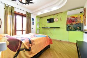 a bedroom with a bed in a room with green walls at Casa Etnica ID 26215 in Latina