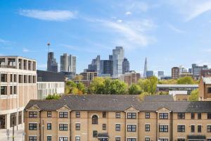 a building with a city in the background at Modern New 1-Bedroom Home Stunning Views in London