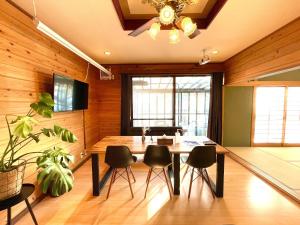 a dining room with a table and black chairs at Agatsuma-gun - House - Vacation STAY 26682v in Kusatsu