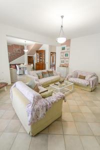 a large living room with couches and tables at SanVitoTour- Residence Il Baglio in San Vito lo Capo