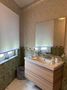 a bathroom with a sink and a mirror at CASA DE LA NIÑA,Chalet familiar con gran terraza in Fisterra