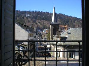 a view from a window of a church with a steeple at Résidence les Sources Mont Dore in Mont-Dore