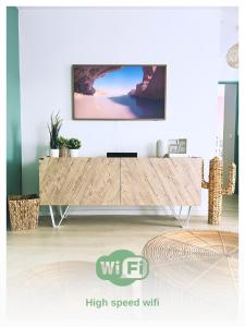 a living room with a tv on a wall at L'Organik Disney 7 min Gare 5 min parking privé in Chessy