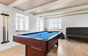 a room with a pool table and a couch at Nice Home In Grenaa With Wifi in Grenå