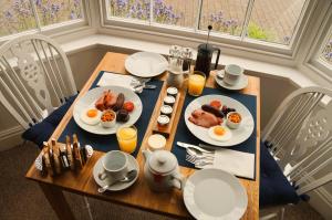 a table with two plates of breakfast food on it at Radcliffe Guest House in Ross on Wye