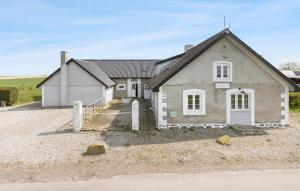 a house with a gravel driveway in front of it at Nice Home In Grenaa With Wifi in Grenå