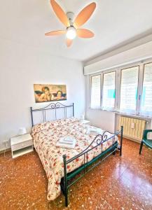 a bedroom with a bed and a ceiling fan at A Due Passi Dal Mare in Lido di Camaiore