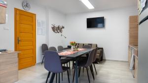 a dining room with a table and chairs at Csobogó-patak Vendégház in Erdőhorváti
