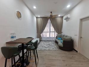 a living room with a table and a couch at Inap Ani Putrajaya in Putrajaya