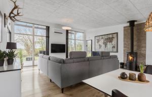 a living room with a couch and a table at Four-Bedroom Holiday Home Haderslev With A Room Hot Tub 09 in Knud