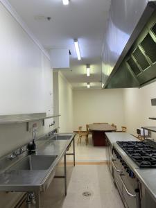 a kitchen with a sink and a stove at Broadway Central Apartment in Sydney