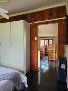 a bedroom with a bed and a dining room at 11-on-RobRoy serenity glamping cabins overlooking the Valley of 1000 Hills in Hillcrest