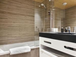 a bathroom with a shower and a sink and a tub at Saskya 5 65m2, 2 bedrooms, next to the ski lift in Samoëns +17 photos
