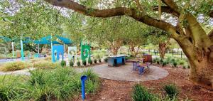 un parc avec un banc et une aire de jeux dans l'établissement Serenity And Comfort In Subiaco 1 Bedroom Unit, à Perth