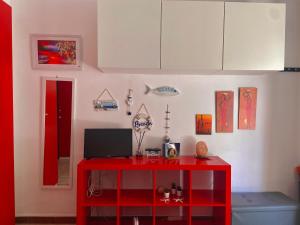 a red table with a laptop on it in a room at Albachiara in Giovinazzo