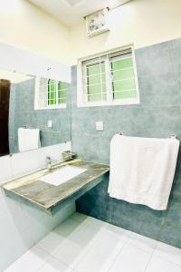 a bathroom with a sink and a mirror at Sj Luxury Suits in Lahore