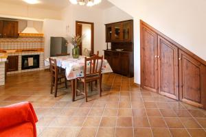 a kitchen and dining room with a table and chairs at SanVitoTour- Residence Il Baglio in San Vito lo Capo