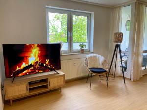 un soggiorno con TV a schermo piatto e camino di Bamboo Village a Magdeburgo