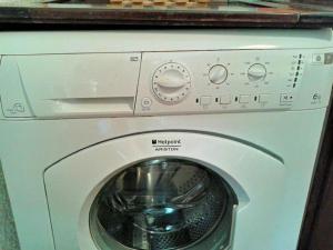 a washing machine with a washer under a counter at Casa vacanze Dolce Glicine in Bonassola +20 photos