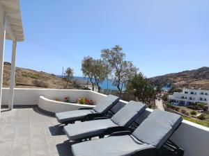 a group of chairs sitting on a patio at Summer House Paliochori in Paliochori