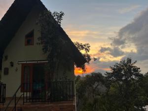 ein Haus mit Sonnenuntergang im Hintergrund in der Unterkunft Twilight Villas in Rattota