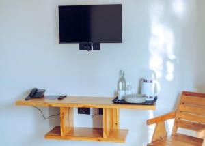 a wooden table with a television on top of it at The Maridadi Hotel in Moshi