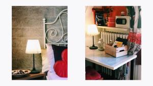 a room with a bed and a table with a lamp at Europe Station Rooms in Parma