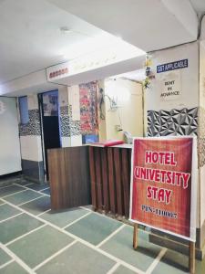 a hotel university stay sign in a room at Hotel University Stay @ A1Rooms in New Delhi