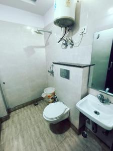 Hotel University Stay @ A1Rooms في نيودلهي: حمام مع مرحاض ومغسلة