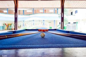 a billiard table with a ball in the middle at New Green Horse Hotel in Cotonou