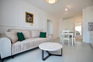 a living room with a couch and a table at Promenada Gwiazd 14 by Baltic Home in Międzyzdroje