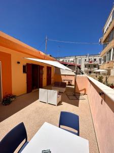 a balcony with tables and chairs on a building at Affittacamere Villa Ginevra in Gallipoli +8 photos