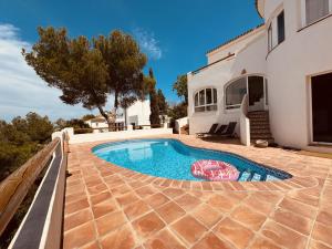 a swimming pool in the backyard of a house at Ibiza Dream Villa Denia, Seaview, Pool, BBQ, Airco, Wifi in Denia