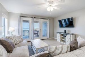 a living room with a couch and a tv at Bonhomme Richard East in Gulf Shores